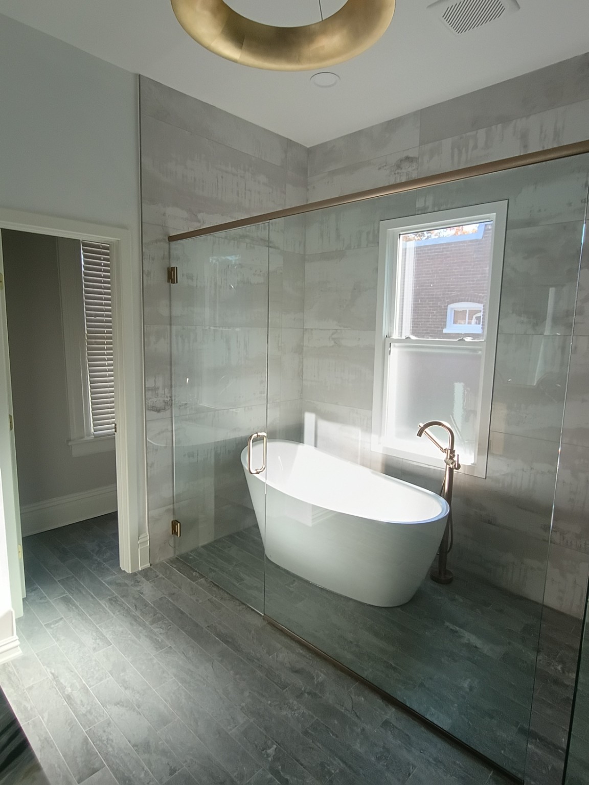 Bathroom with glass shower enclosure and freestanding tub